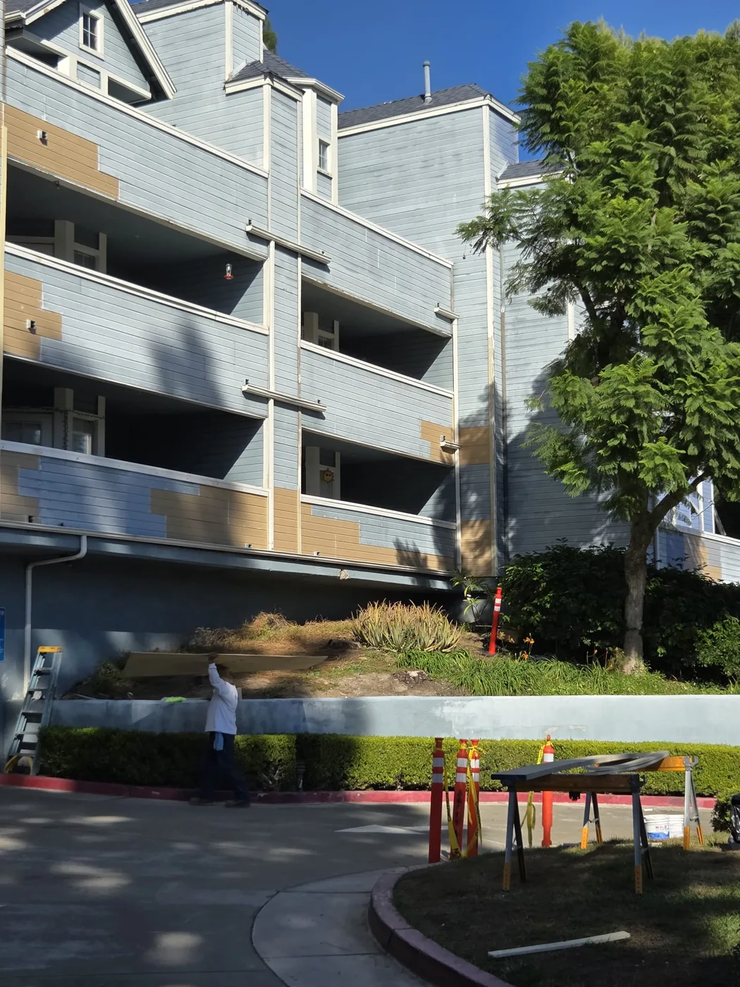 Corner view of an apartment building being repainted